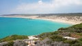 View from hill to beautiful, unspoiled beach, no people, with ca