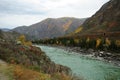 A view from the hill to the bend of a beautiful turquoise river flowing through an autumn valley in the mountains Royalty Free Stock Photo