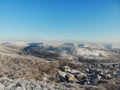 View from the hill to winter landscape with farmstead and forest, scenic winter view to valley, tranquil winter countryside,