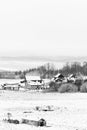 View from the hill to winter landscape with farmstead and forest, scenic winter view to valley