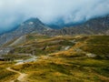 View of the hills and mountains under cloudy sky in Gran Paradiso National Park, Italy