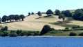 A view of hilly fields looking across Wimbleball lake in Exmoor, UK