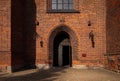 View of a historic brick cathedral in Poznan, Poland, with an ornate entrance