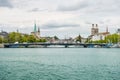 View of the historic buildings and bridge of Zurich at the bank of Limmat River and Zurich lake, with landmark of FraumÃÂ¼nster Royalty Free Stock Photo