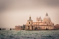 View of historic buildings surrounded by water in the morning mist in the city of Venice