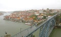 View of the historic city of Porto, Portugal with the Dom Luiz bridge. A metro train can be seen on the bridge Royalty Free Stock Photo