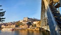 View of the historic city of Porto, Portugal with the Dom Luiz bridge. A metro train can be seen on the bridge Royalty Free Stock Photo