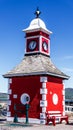 View of the historic clock tower and weigh station on the Royal Pier of Knight`s Town on Valentia Island in County Kerry