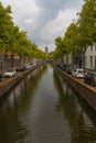 View of historic oude canal leading to view of the Oude Kerk in Delft