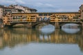 View of the historic Ponte Vecchio with gorgeous reflections in the Arno river during winter season, Florence, Tuscany, Italy Royalty Free Stock Photo