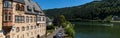 View of the historic post office in Traben-Trarbach and the Mosel River with a boat headed upstream