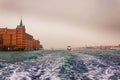 View of historical buildings surrounded by water in the morning mist in the city of Venice