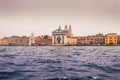 View of historical buildings surrounded by water in the morning mist in the city of Venice