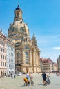 View of historical center, Church of our Lady and Neumarkt square in downtown of Dresden with two modern cyclists in summer with