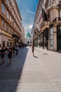 View on Hofburg Palace from Kohlmarkt street, wide-angle view at sunny day with tourists