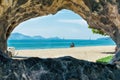 View through hole in stone on beach and ocean vacation Royalty Free Stock Photo