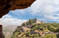 View through a hole in the wall to the ruins of fortress walls and towers of the medieval fortress of Nimrod - Qalaat al-Subeiba