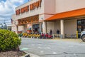 View of Home Depot building and sign with people social distancing