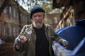 View of homeless man holding empty bottle in hand. Royalty Free Stock Photo