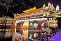 View of Hong bridge Rainbow bridge at night over the Tuojiang River Tuo Jiang River in Fenghuang old city Phoenix Ancient