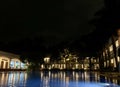 View of a hotel with a big pool in front of it  at night Royalty Free Stock Photo