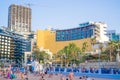 View of the hotel buildings by the beach with people enjoying the summer in Paceville, Malta