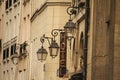 View of a hotel on a corner of a street with old lamps in Paris, France