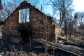 View of the house destroyed after the fire. The consequences of a forest fire in the village. Charred walls of a brick house close Royalty Free Stock Photo