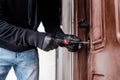View of housebreaker in leather gloves