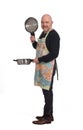 Househusband looking at a pot with food on white background