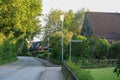 View of houses and empty road with lamp post in rural Germany with bright summer sky background Royalty Free Stock Photo