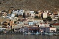 A view of the houses on the hill and seaside with some wooden, traditional fishing boats in Calymnos Island