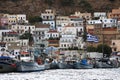 A view of the houses on the hill and seaside with some wooden, traditional fishing boats in Calymnos Island