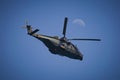 Hovering military helicopter at the blue sky Royalty Free Stock Photo