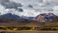 View on a huge mountain and small house in Iceland with dramatic sky Royalty Free Stock Photo