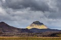 View on a huge mountain and small house in Iceland with dramatic sky Royalty Free Stock Photo