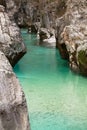 View on huge rocks in gorge canyon with turquoise green crystal clear river soca Royalty Free Stock Photo