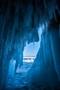 View from an ice cave with huge blue icicles on Lake Baikal.