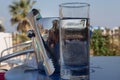 Ice container and glass with water on the table Royalty Free Stock Photo