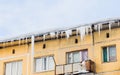 Icicles and snow on the roof of the house Royalty Free Stock Photo