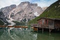 View of iconic boathouse and boats with mount Seekofel mirroring in Pragser Wildsee Lago di Braies Italy