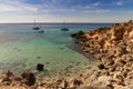 view of an idyllic cove at Es Cap Enderrocat in southern Mallorca with sailboats at anchor Royalty Free Stock Photo