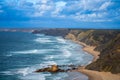 View of idyllic nature landscape with rocky cliff shore and waves crashing on