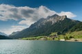 View of an idyllic and picturesque turquoise mountain lake surrounded by green forest and mountain peaks in the Swiss Alps