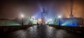 View of the illuminated Charles Bridge in Prague, Czech Republic, during a winter night with fog
