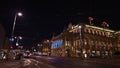 View of the illuminated facade of the Vienna State Opera building in Austria by night with tram in front. Royalty Free Stock Photo