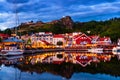 View of the illuminated houses and yachts with Fredriksted fortress at the background in Halden, Norway Royalty Free Stock Photo