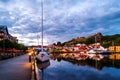 View of the illuminated houses and yachts with Fredriksted fortress at the background in Halden, Norway Royalty Free Stock Photo