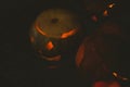 view Illuminated jack o lanterns in darkroom