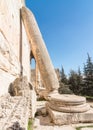 Inclined Roman column leaning against Temple of Bacchus wall, Heliopolis Roman ruins, Baalbek, Lebanon Royalty Free Stock Photo